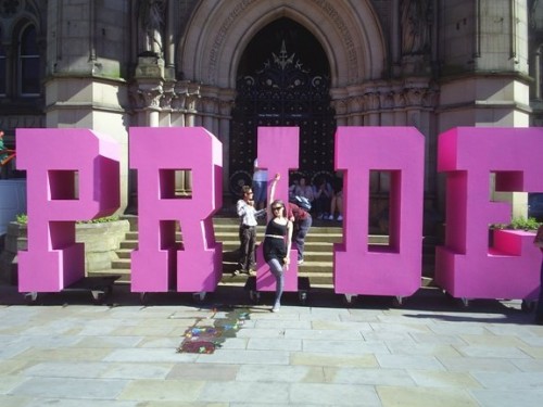 A member of 'The Bet Lynch Mob' dancers enjoys 'Pride' (letters by Hugh Jart)