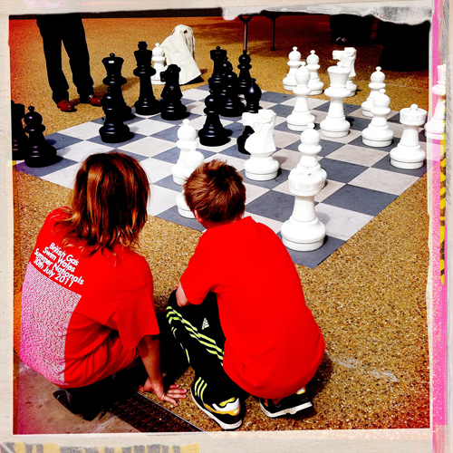 after the art gallery and on route to the library the boys discuss the strategic moves on the chess board...