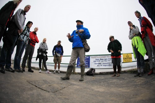 Sand Pilot - image of Rich Warburton of Invisible Flock preparing the group for their audio walk across the bay