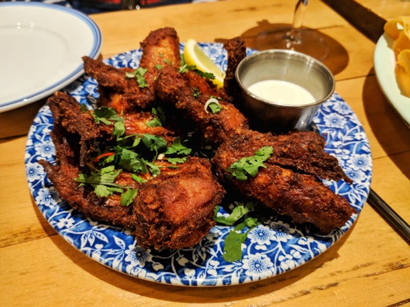 Chicken wings garnished with coriander and chilli