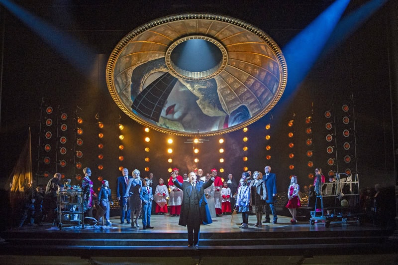 Robert Hayward as Scarpia and the Chorus of Opera North in Opera North’s production of Puccini’s Tosca (Photo credit: Richard H Smith)